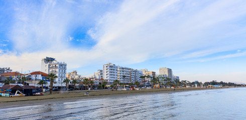 Finikoudes beach, city of Larnaca, Cyprus. Blue sky with few clouds background.