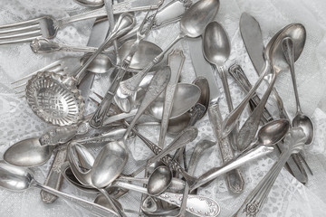 Silverware on a white lace