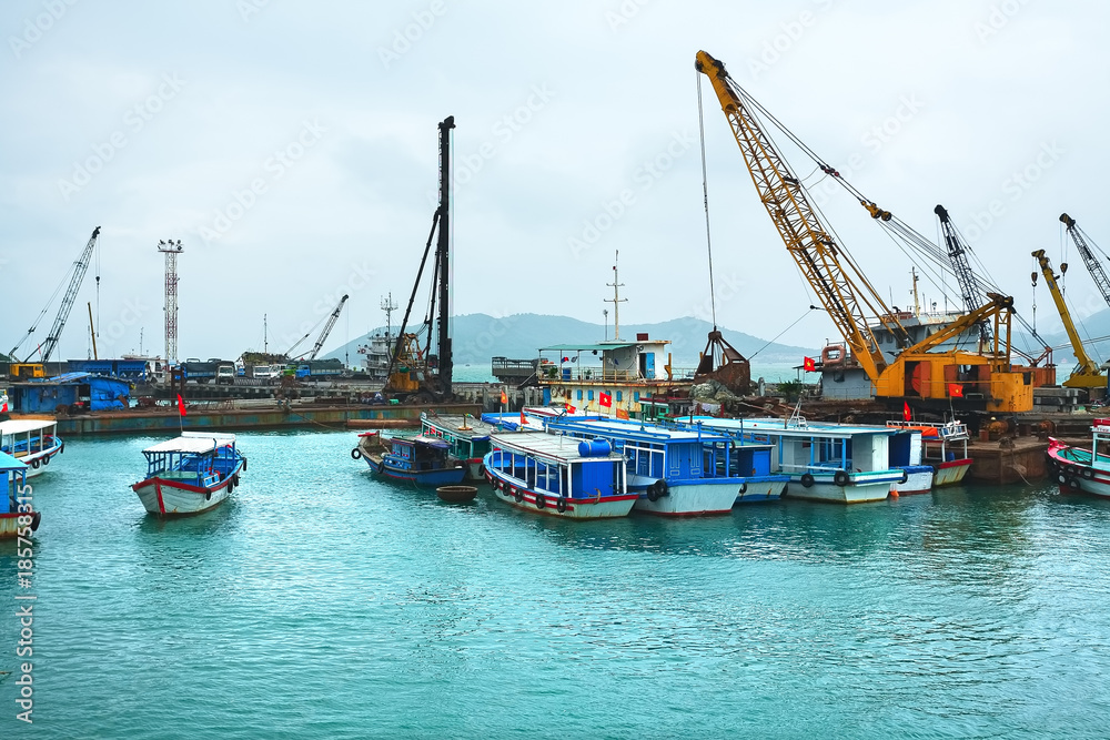 Wall mural seaport, boats and loading cranes. asia