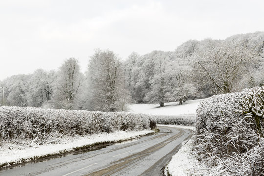 Hedge Lined Country Lane Surrounded by Snowy Fields in Winter, Penn, Buckinghamshire, England, UK