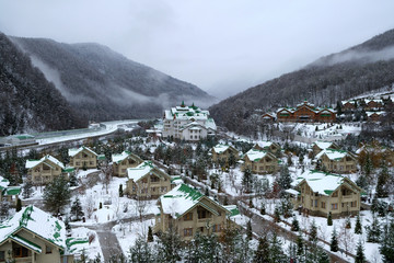 Fototapeta na wymiar Cozy houses in snowy mountains. Krasnaya Polyana