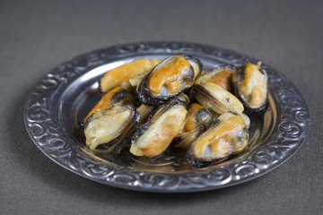 Fried mussels on a metal plate