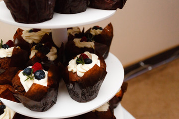 Cake and cupcakes in the center with a large tray with wheels