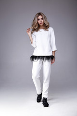 Sexy pretty beautiful woman fashion style clothes model perfect face makeup wear white casual suit feather curly blond hair luxury glamour walk date party accessory catalog beauty salon shoes sneakers