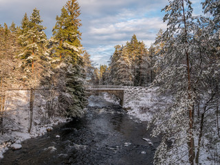 The cold snow winter river in evening light