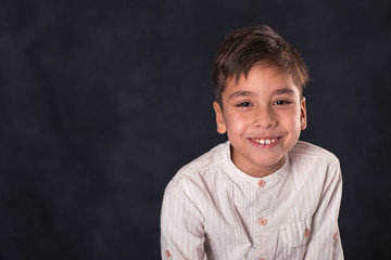 portrait of  the schoolboy of the brunette in a white shirt