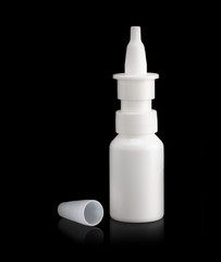 White bottle with a medicine cap on a black background