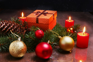 christmas decoration with gift boxes, red candles, christmas tree and colorful balls. Selective focus.