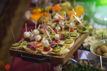 bread with cucumber and sweet meat on wood plate with fork
