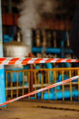 Fencing with an alarm tape. Zone of increased danger. Steam turbine during the repair. Equipment,...