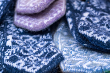 Bunch of handmade colorful woolen mittens
