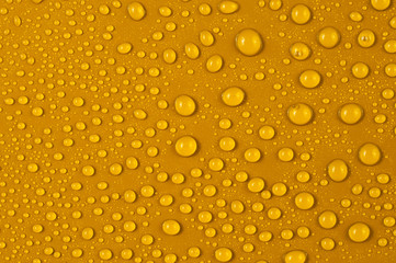 Texture of water drops on a yellow background