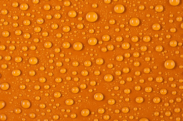 Texture of water drops on a orange background