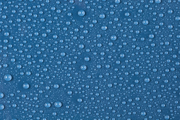 Naklejki  Texture of water drops on a blue background