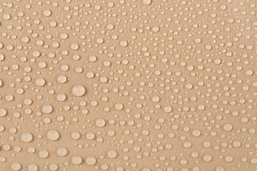 Texture of water drops on a beige background
