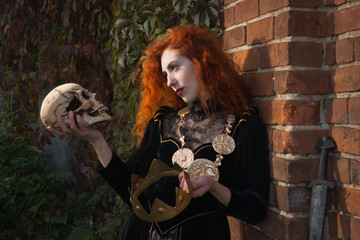 Medieval Queen with a sword in one hand and a skull