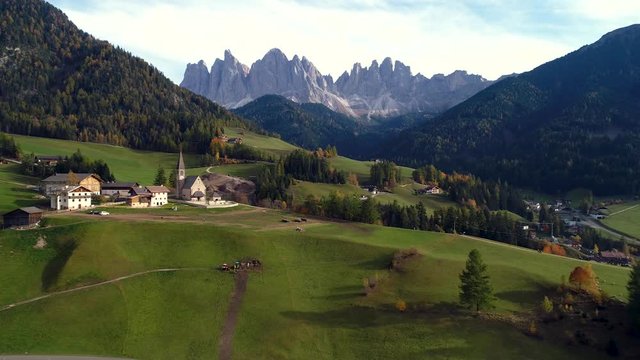 Beautiful mountain view of Alpine village, green meadows and pastures, peaks. Dolomiti Alps of South Tyrol