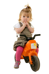 Portrait of a sweet little girl riding a motorbike