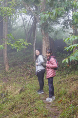 Asia girl Mother and daughter backpack behind go hiking or climbing in Nature Mountain.