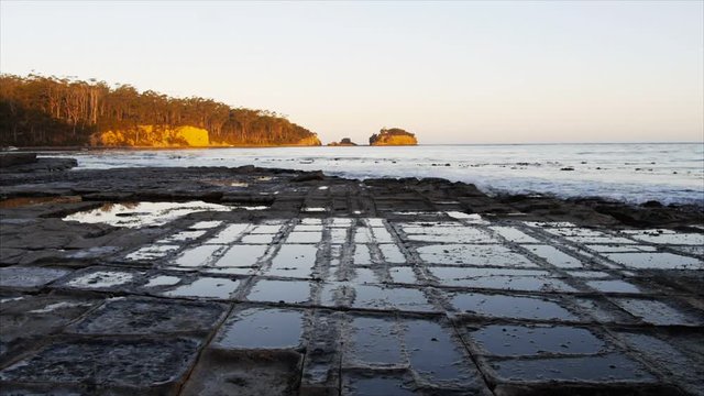 tessellated pavement at eaglehawk neck near port arthur, tasmania at sunset