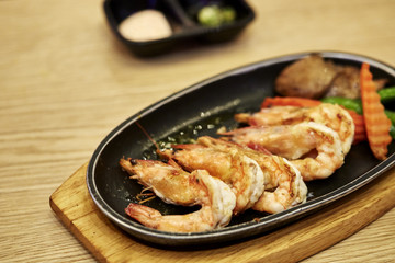 Japanese seafood. Fried spicy shrimps with herbs
