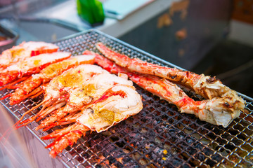 Delicious grilled crab on stove at Kuromon Ichiba Market