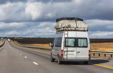 A mini bus moves along the road.