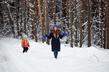 Fototapeta na wymiar winter fun. boy with a girl walking on a winter road.