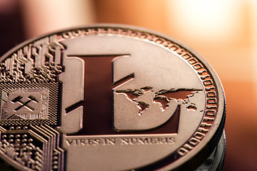 Coin litecoin closeup on a beautiful background. Conceptual image of a digital cryptocurrency and payment system.