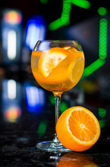 Tonic water cocktail with rosemary and orange. Two glasses with zest sugar and bubbles with textile over dark texture metal background. Refreshing beverage alco non alcohol