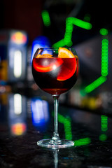 Close-up detail of a wine glass filled with Sangria, a traditional spanish cocktail, in a local restaurant. Valencia Spain. Travel and local cuisine concept.