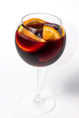 Raspberry lemonade jug with two wine glasses, orange citrus slices. wooden table background. top view
