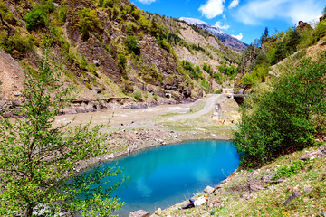 Fototapeta na wymiar Panoramic view of crystal blue lake and woodland in Georgia. Lajanuri reaservoir near Usakhelo, Racha. Caucasus. Colorful vibrant outdoors