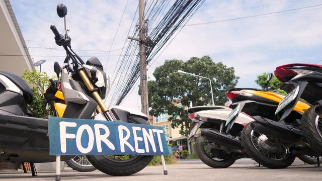 Motorbikes for Rent Sign at Bike Rental Shop. 4K. Thailand.