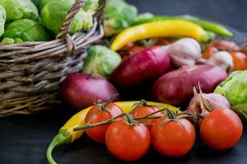 Traditional Latin American mexican Tomato sauce salsa, chilean chancho en piedra in stone mortar and ingredients tomatoes, chile, garlic, onion, dark slate stone background. Top view.