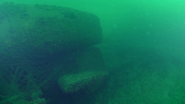 The aft part of a sunken submarine with rudders of depth and direction.
