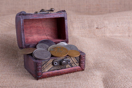 Wooden chest and old coins