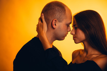 Girl and boy on the background of a sunset color