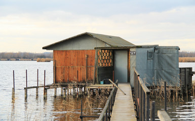 bizzare post-apo looking cottage with narrow catwalk on Hermanicky pond, Czech Republic