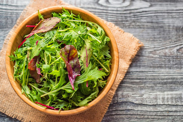 Fresh rustic vegetable salad on rustic background