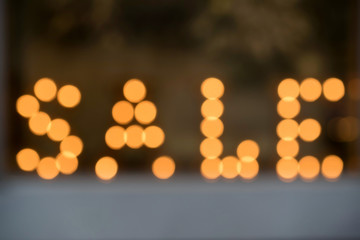 Christmas sale text made of defocused bulb lamps