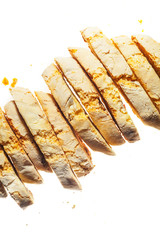 Cantuccini - traditional italian biscuits with almond isolated on white background. Close up image of sliced loaf