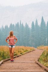 Young girl exploring Yosemite National Park near California by lakes forests and mountains 