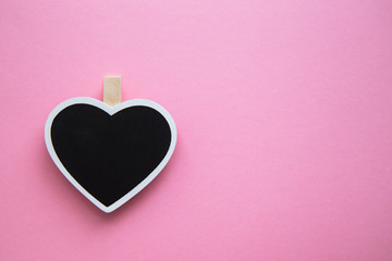 the chalk Board for notes in shape of heart on pink background.postcard the heart of minimalism. the concept of Valentine's day