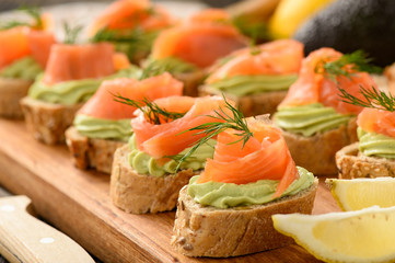 Canape with smoked salmon and guacamole.