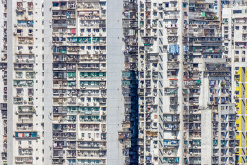 Fototapeta na wymiar High-rise traditional condominium building in Macau completely fill up the frame. The patterns of edges, windows, balconies, and air conditioning systems.