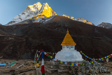 Buddhist stupa on mountain trekking path in Himalayas, Nepal.