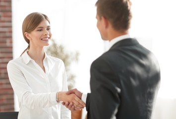 handshake young business woman with a colleague