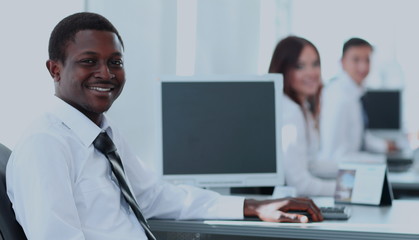 Fototapeta premium Portrait of happy afro-american businessman with colleagues wo