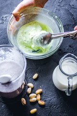 organic ice cream homemade process on dark background with hands